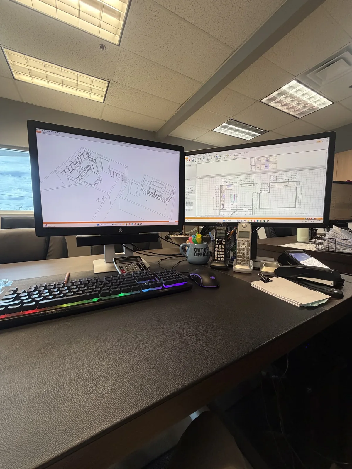 Design workstation with two monitors showing a kitchen floor plan and 3D model