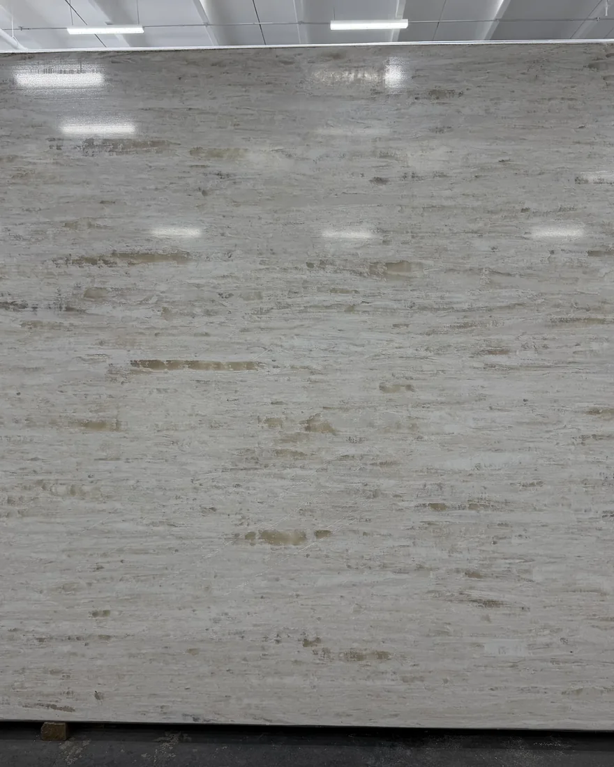 Full stone slab under warehouse lights, reviewed before fabrication