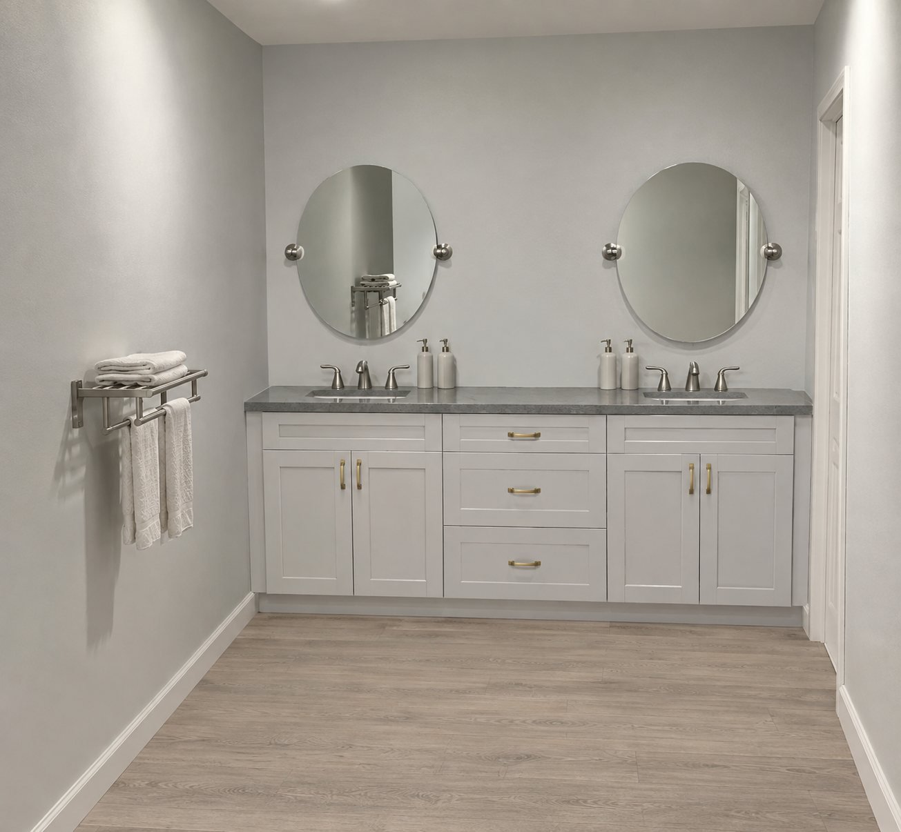 Bathroom with a white double vanity, round mirrors and a grey stone top