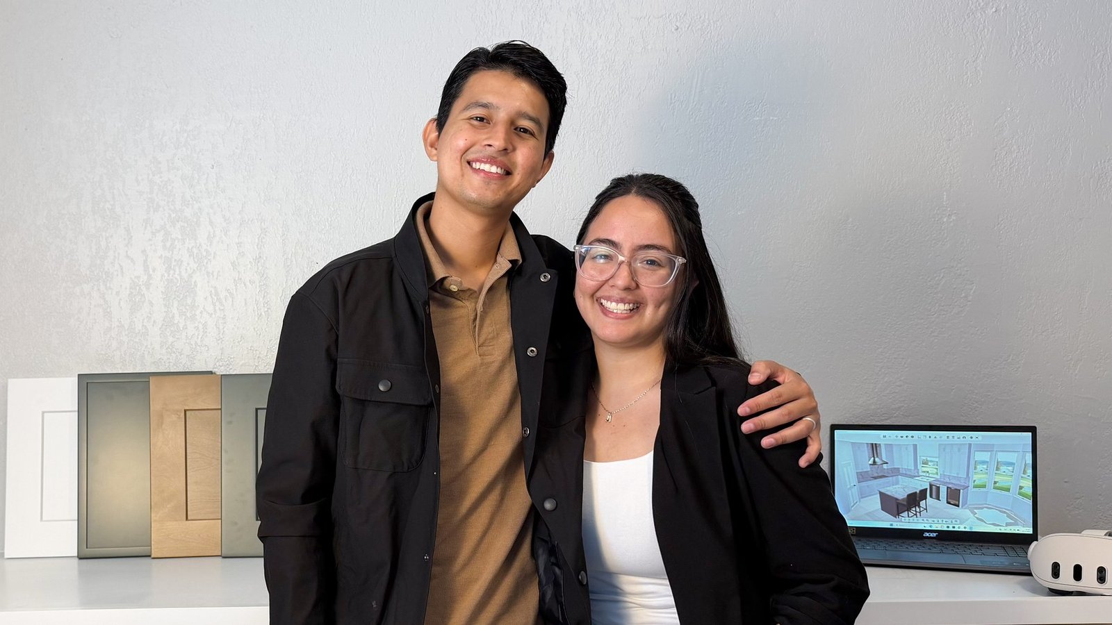 Arianna and Daniel, founders of D’Panim Remodeling, with cabinet door samples on one side and the 3D kitchen design on the laptop on the other