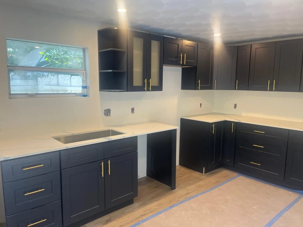 Navy L-shaped kitchen during installation