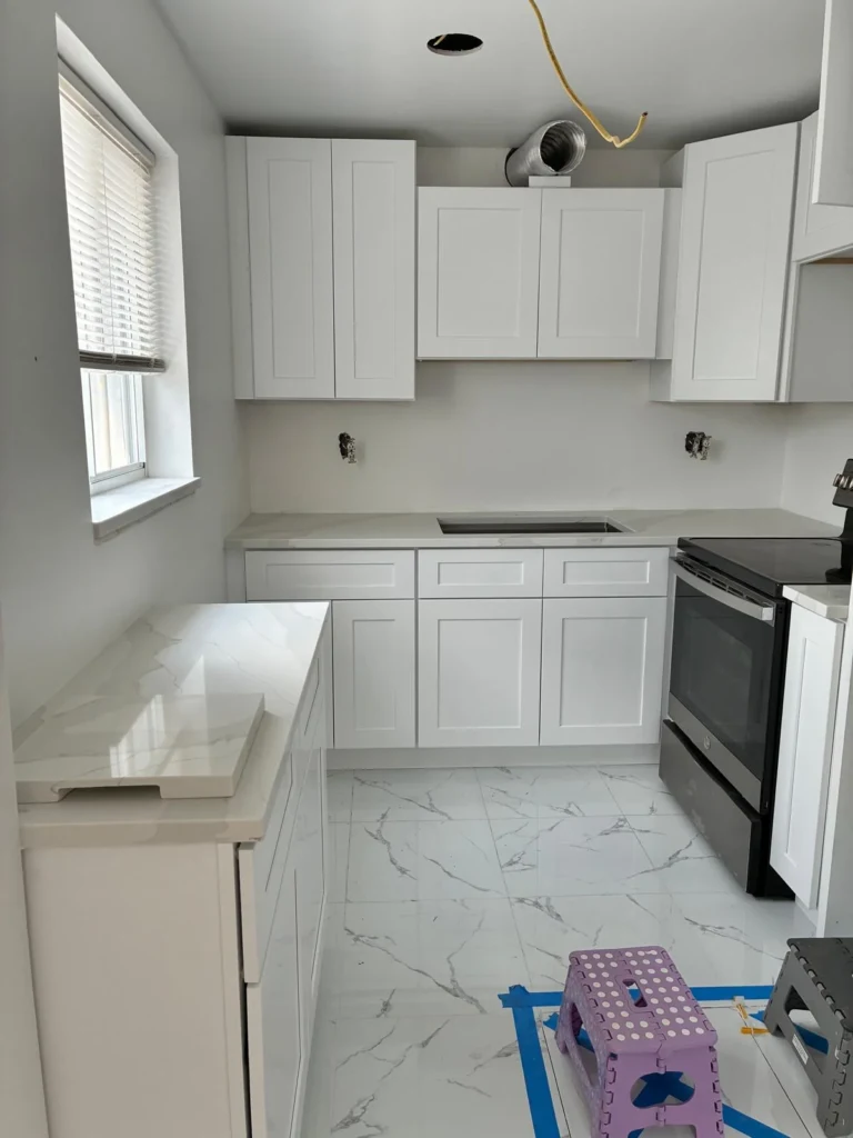 White shaker kitchen during installation