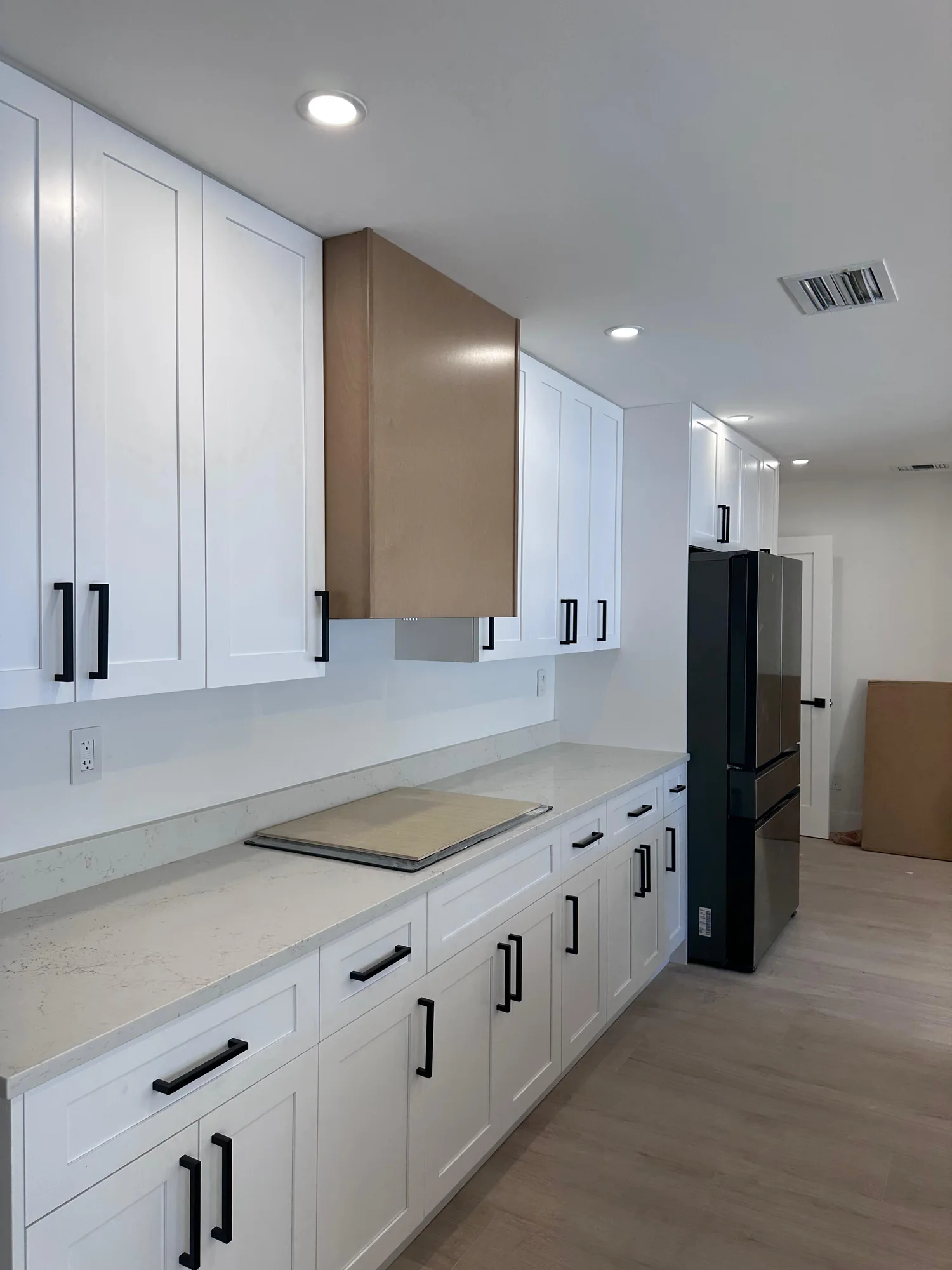 Long run of white shaker cabinets